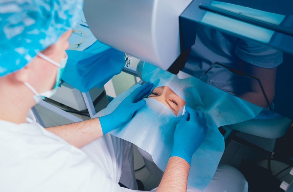 An ophthalmologist prepares a patient for LASIK surgery.