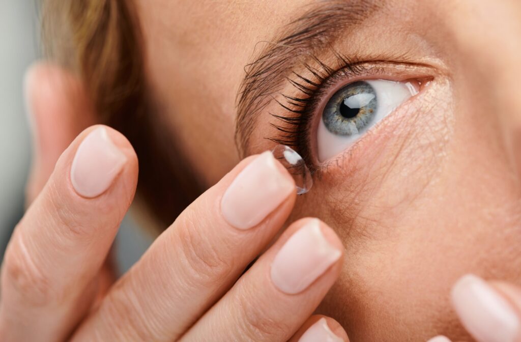 A person inserts a soft contact lens.