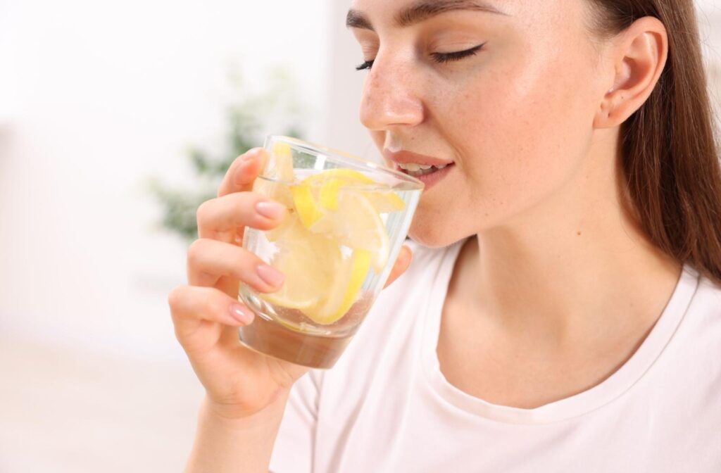 A person drinking a glass of water.