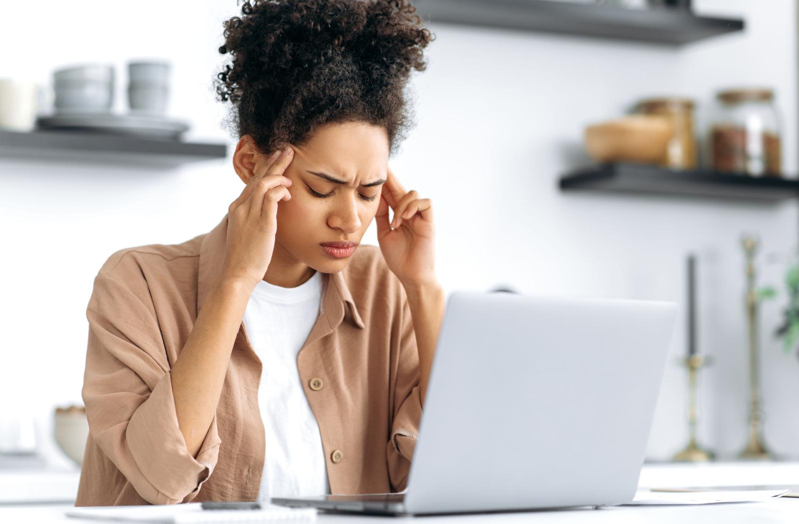 A person experiencing eye strain and dry eyes from computer vision syndrome.